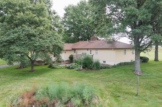 20723 Kissinger Rd, Tonganoxie, KS 66086 - back of house featuring a lawn and a chimney