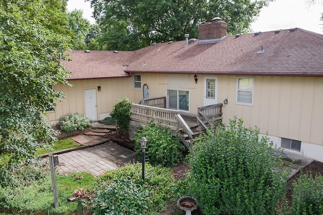 20723 Kissinger Rd, Tonganoxie, KS 66086 - rear view of house with a shingled roof, a chimney, and a wooden deck