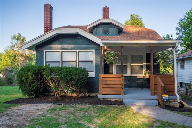 5409 Brooklyn Ave, Kansas City, MO 64130 - bungalow with covered porch and a chimney