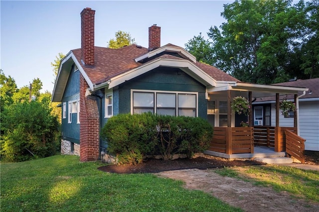 5409 Brooklyn Ave, Kansas City, MO 64130 - bungalow-style home with a front lawn, a porch, a chimney, and a shingled roof