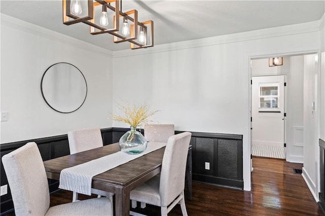 5409 Brooklyn Ave, Kansas City, MO 64130 - dining area featuring a chandelier, wood finished floors, and crown molding