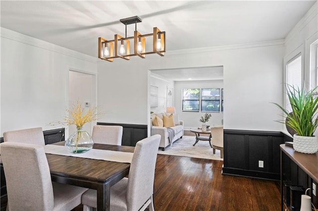 5409 Brooklyn Ave, Kansas City, MO 64130 - dining room featuring a chandelier, dark wood-style floors, and crown molding