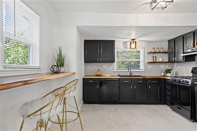 5409 Brooklyn Ave, Kansas City, MO 64130 - kitchen with black appliances, dark cabinetry, light marble finish floors, and backsplash