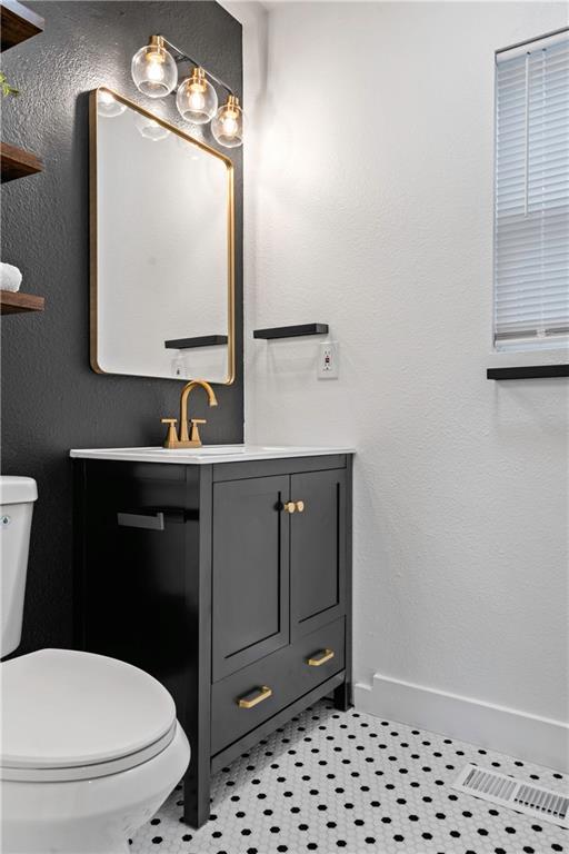 5409 Brooklyn Ave, Kansas City, MO 64130 - bathroom featuring toilet and vanity