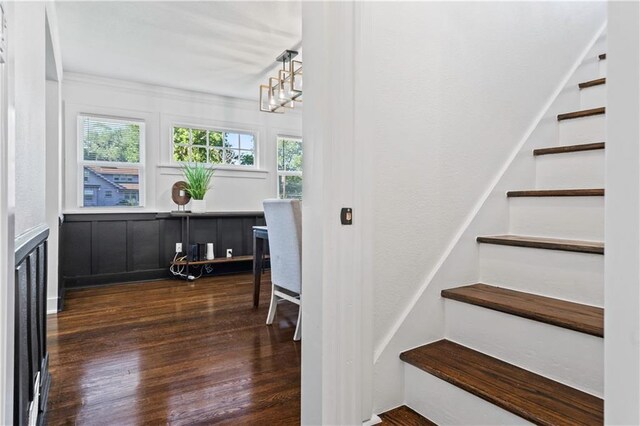5409 Brooklyn Ave, Kansas City, MO 64130 - stairway with wood finished floors and a chandelier
