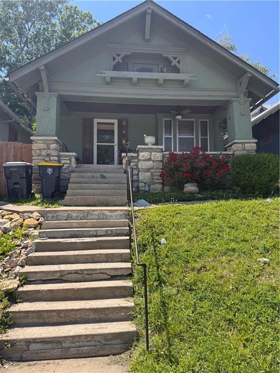 4308 Paseo Blvd, Kansas City, MO 64110 - victorian-style house featuring covered porch, stairs, and stone siding