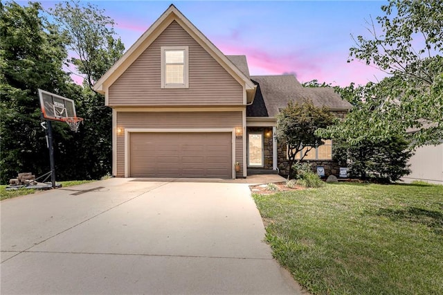 701 Redbud Dr, Paola, KS 66071 - traditional home with a front yard, concrete driveway, and a garage