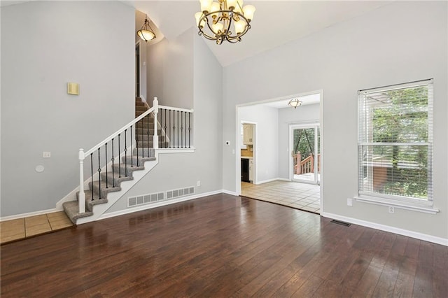 701 Redbud Dr, Paola, KS 66071 - entryway with a chandelier, stairway, hardwood / wood-style floors, and high vaulted ceiling