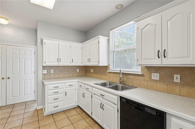 701 Redbud Dr, Paola, KS 66071 - kitchen with black dishwasher, light tile patterned floors, and white cabinets