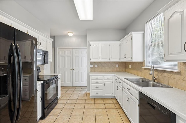 701 Redbud Dr, Paola, KS 66071 - kitchen featuring black appliances, backsplash, white cabinetry, and light tile patterned floors