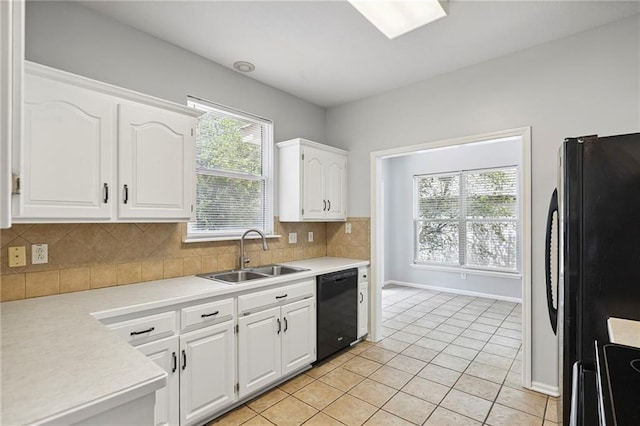 701 Redbud Dr, Paola, KS 66071 - kitchen featuring black appliances, light countertops, white cabinets, and backsplash