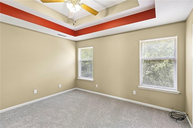 701 Redbud Dr, Paola, KS 66071 - unfurnished room with carpet, a tray ceiling, and a ceiling fan