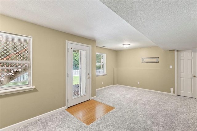 701 Redbud Dr, Paola, KS 66071 - entryway with a textured ceiling and carpet