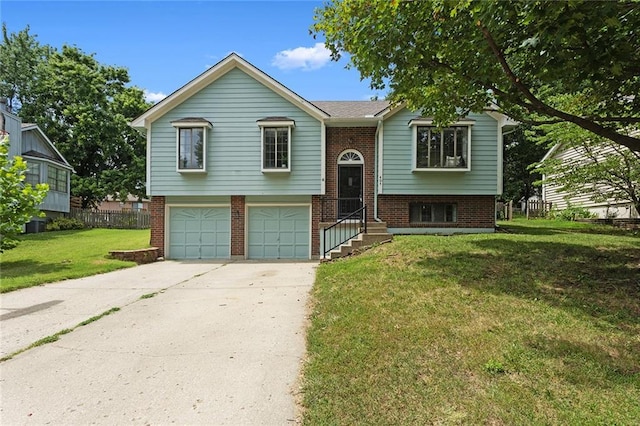 404 SE Bristol Dr, Lees Summit, MO 64063 - split foyer home with brick siding, a garage, concrete driveway, and a front yard