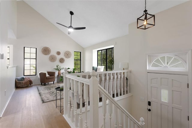 404 SE Bristol Dr, Lees Summit, MO 64063 - hall featuring an upstairs landing, wood finished floors, and high vaulted ceiling