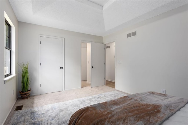 404 SE Bristol Dr, Lees Summit, MO 64063 - bedroom featuring light colored carpet, multiple windows, and a textured ceiling