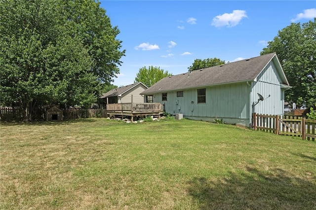 404 SE Bristol Dr, Lees Summit, MO 64063 - back of property with a fenced backyard, a wooden deck, and board and batten siding
