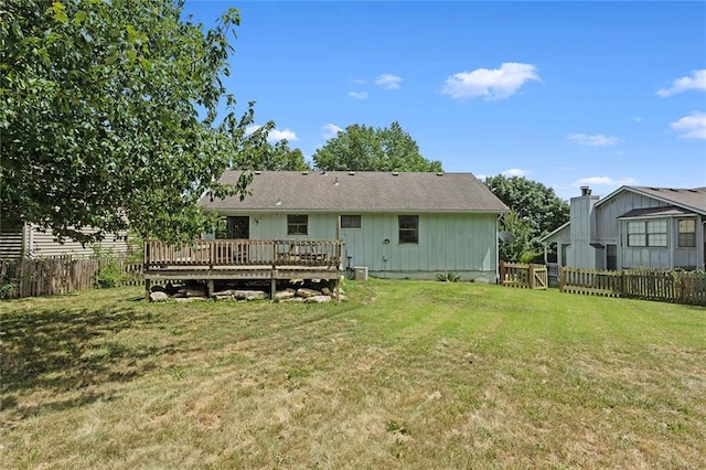 404 SE Bristol Dr, Lees Summit, MO 64063 - rear view of house with a fenced backyard and a wooden deck