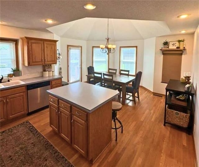 1720 SE Kenwood Dr, Blue Springs, MO 64014 - kitchen with dishwasher, a chandelier, healthy amount of natural light, a textured ceiling, and lofted ceiling