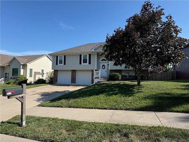 1720 SE Kenwood Dr, Blue Springs, MO 64014 - raised ranch featuring brick siding, concrete driveway, an attached garage, and a front yard