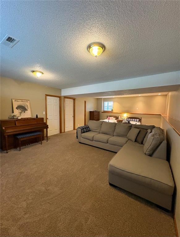1720 SE Kenwood Dr, Blue Springs, MO 64014 - carpeted living area featuring a textured ceiling