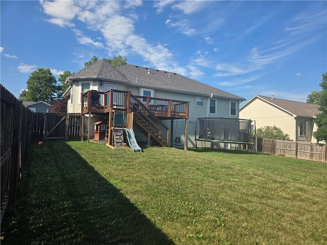 1720 SE Kenwood Dr, Blue Springs, MO 64014 - back of house featuring a trampoline, a wooden deck, a fenced backyard, and stairs