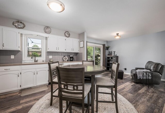 15714 Leavenworth Rd, Basehor, KS 66007 - dining room featuring dark wood finished floors and baseboards