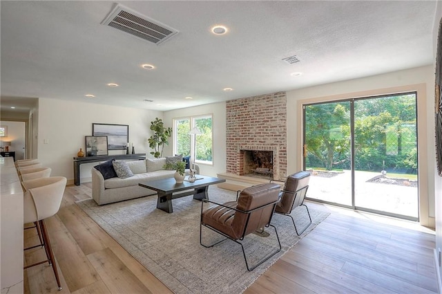 9730 State Line Rd, Leawood, KS 66206 - living area with a fireplace, wood finished floors, and recessed lighting