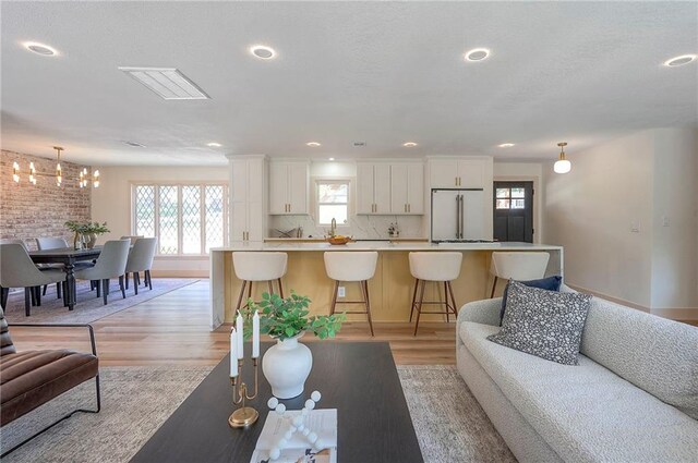 9730 State Line Rd, Leawood, KS 66206 - living room with light wood finished floors, a chandelier, and recessed lighting