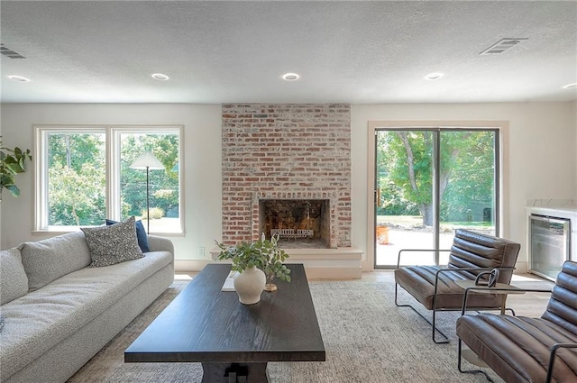 9730 State Line Rd, Leawood, KS 66206 - living room with a brick fireplace, a textured ceiling, and recessed lighting