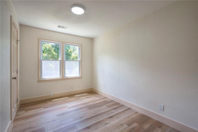 9730 State Line Rd, Leawood, KS 66206 - empty room with light wood-style floors and a textured wall