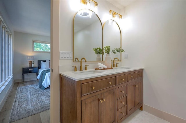 9730 State Line Rd, Leawood, KS 66206 - full bath with double vanity, ensuite bath, and wood finished floors