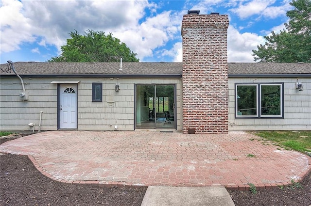 9730 State Line Rd, Leawood, KS 66206 - rear view of property featuring a chimney, a patio area, and roof with shingles