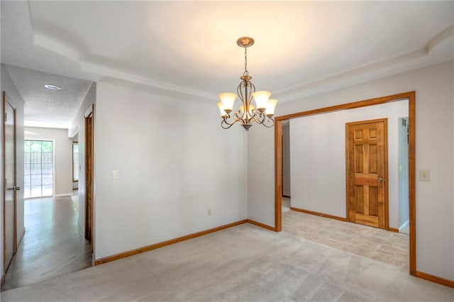11512 Hadley St, Overland Park, KS 66210 - unfurnished room featuring a chandelier, a raised ceiling, and light colored carpet