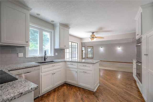 11512 Hadley St, Overland Park, KS 66210 - kitchen with a peninsula, backsplash, white cabinetry, ceiling fan, and a textured ceiling