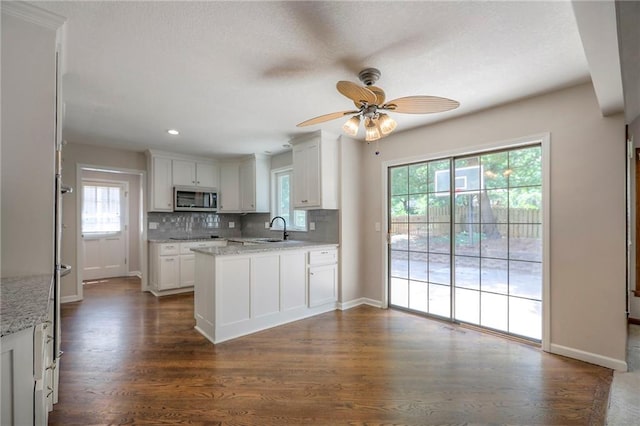 11512 Hadley St, Overland Park, KS 66210 - kitchen with stainless steel microwave, plenty of natural light, backsplash, ceiling fan, and recessed lighting
