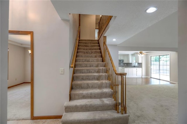 11512 Hadley St, Overland Park, KS 66210 - staircase featuring carpet, high vaulted ceiling, ceiling fan, and recessed lighting