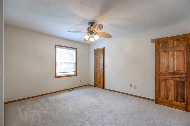 11512 Hadley St, Overland Park, KS 66210 - spare room featuring light carpet, ceiling fan, and a textured ceiling
