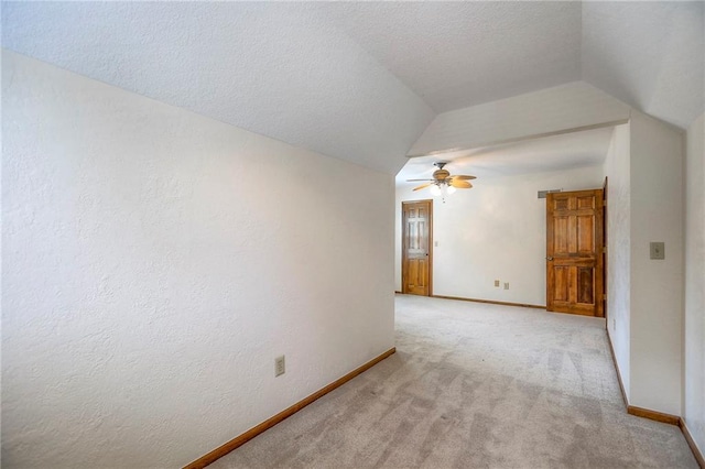 11512 Hadley St, Overland Park, KS 66210 - empty room with lofted ceiling, light colored carpet, ceiling fan, and a textured ceiling