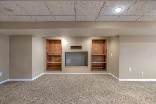 11512 Hadley St, Overland Park, KS 66210 - unfurnished living room with carpet floors, built in shelves, and a drop ceiling