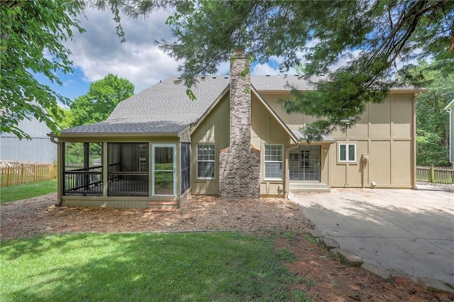 11512 Hadley St, Overland Park, KS 66210 - rear view of house featuring a sunroom, a chimney, a patio area, roof with shingles, and stucco siding