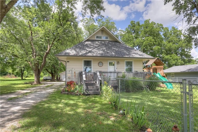 2509 E 4th St, Pittsburg, KS 66762 - bungalow with roof with shingles, driveway, and a playground