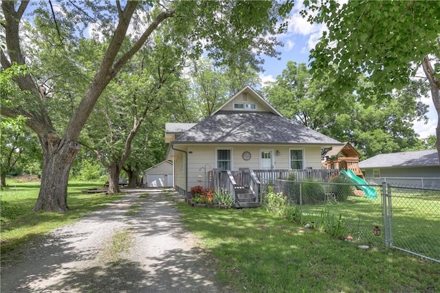 2509 E 4th St, Pittsburg, KS 66762 - bungalow-style house with a playground, a shingled roof, an outdoor structure, and a detached garage