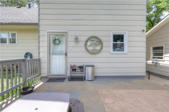 2509 E 4th St, Pittsburg, KS 66762 - view of exterior entry featuring a patio and a shingled roof