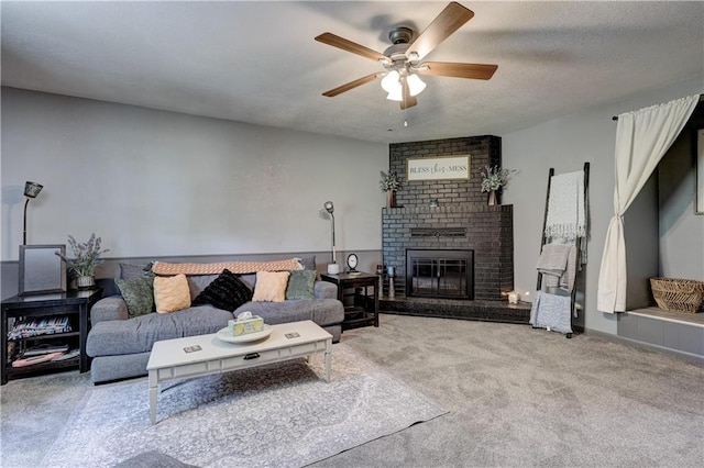 2509 E 4th St, Pittsburg, KS 66762 - living room with a ceiling fan, a brick fireplace, and carpet