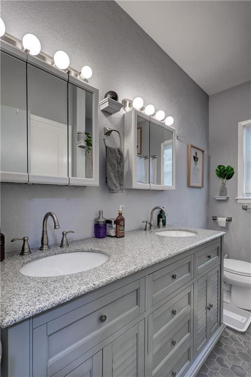 2509 E 4th St, Pittsburg, KS 66762 - bathroom featuring double vanity and tile patterned flooring