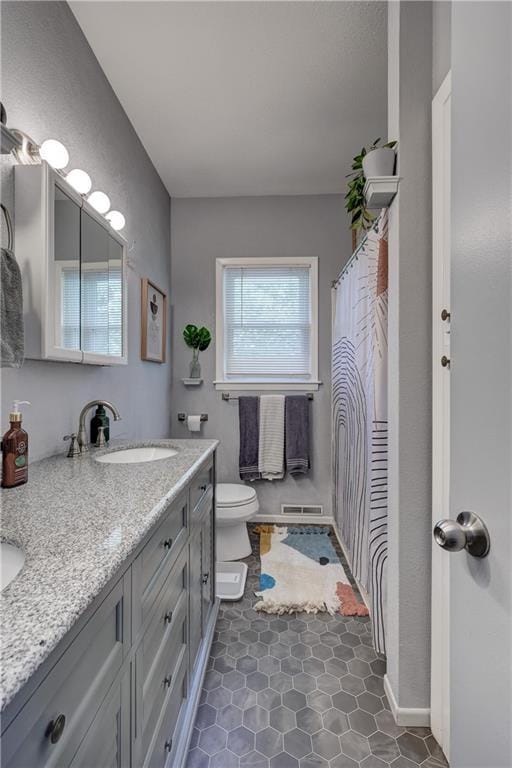 2509 E 4th St, Pittsburg, KS 66762 - bathroom with double vanity and tile patterned flooring