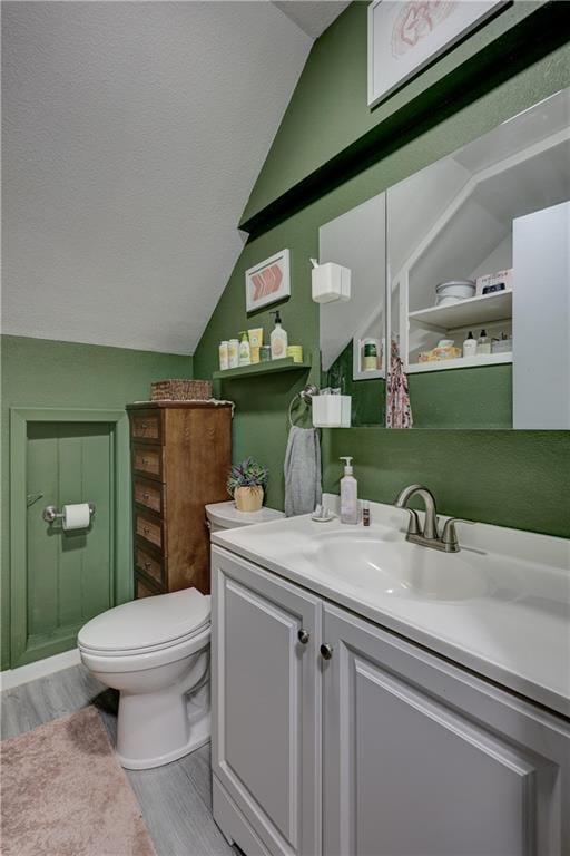 2509 E 4th St, Pittsburg, KS 66762 - bathroom with vaulted ceiling, vanity, and wood finished floors