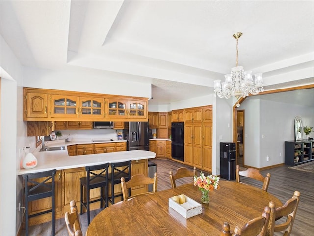 529 SE Dd Hwy, Warrensburg, MO 64093 - dining space featuring a chandelier, dark wood-type flooring, and a tray ceiling