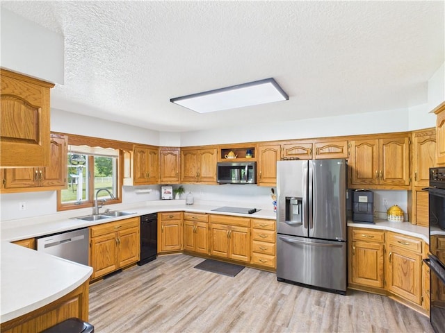 529 SE Dd Hwy, Warrensburg, MO 64093 - kitchen with black appliances, a textured ceiling, light wood finished floors, light countertops, and open shelves